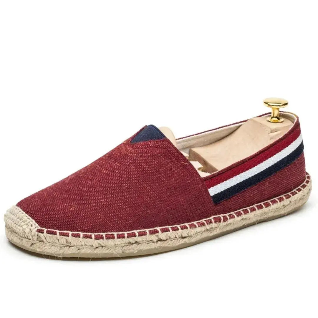 Men's navy canvas slip-on loafers with signature stripe detailing and breathable coastal-inspired design