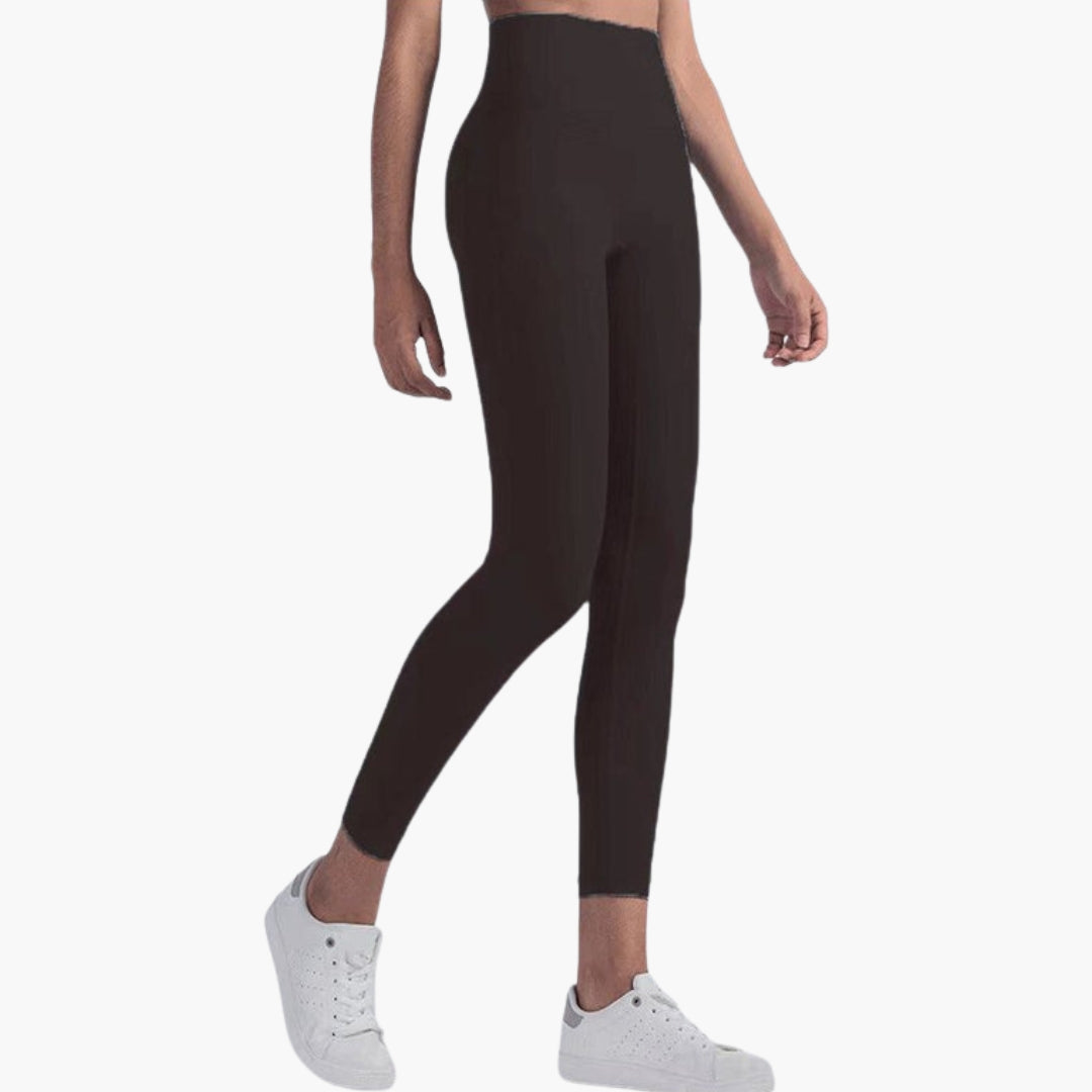 High-waisted women's sports leggings full-length stretch fabric sleek pocketless gym-ready active fit