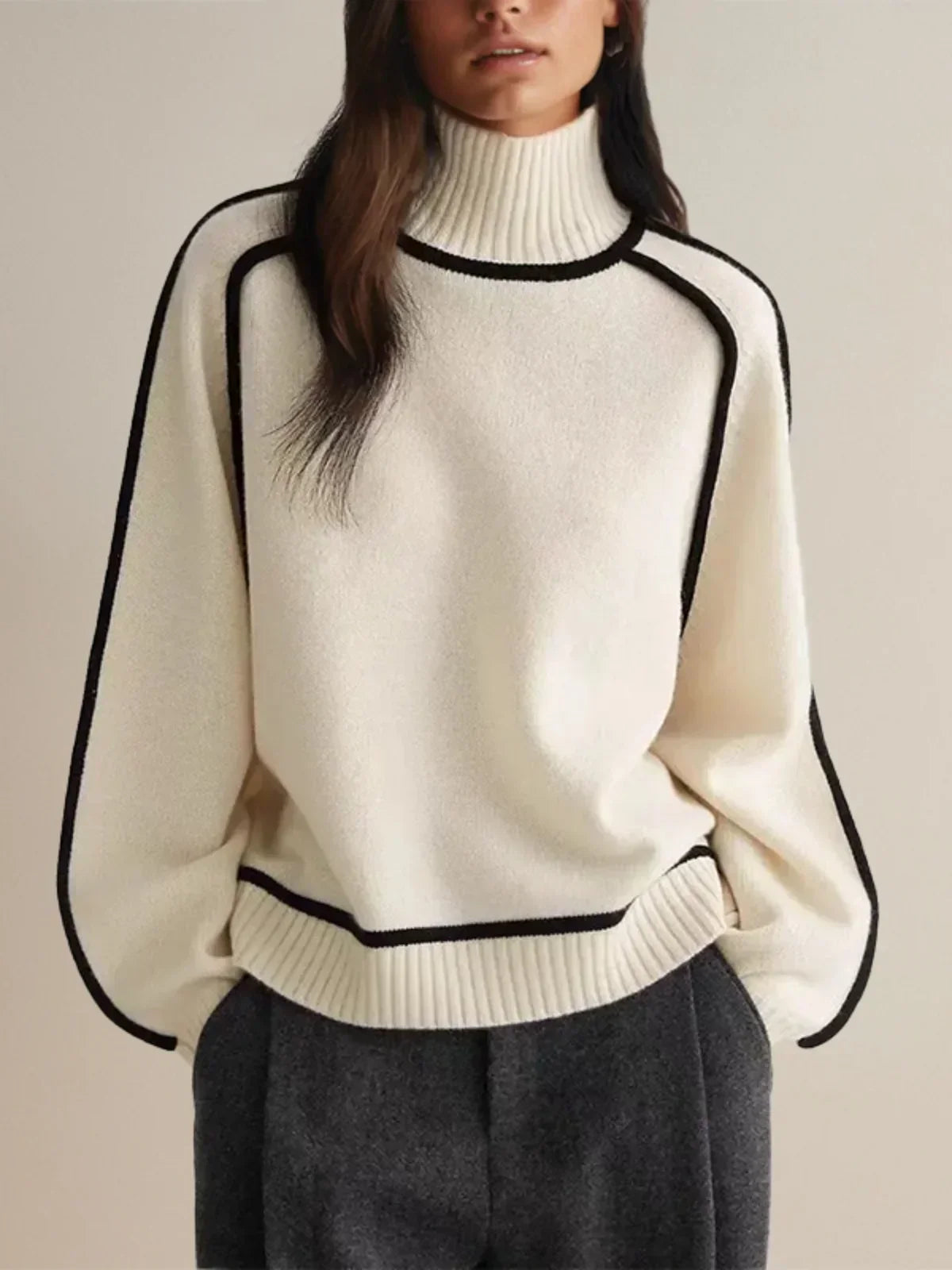 Ivory knit turtleneck sweater with black contrast trim seams, sleek architectural cut for professionals