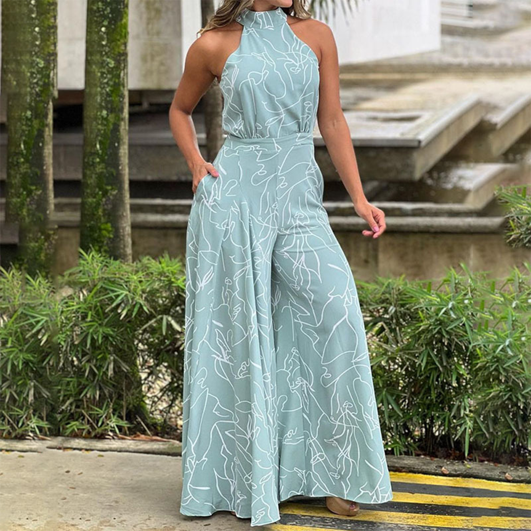 Women's black halterneck maxi dress with long flowing silhouette and graceful draping for day-to-night wear