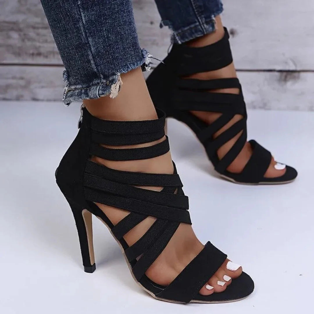 Women's black suede high heel sandals with bold cutout straps for glamorous night out styling