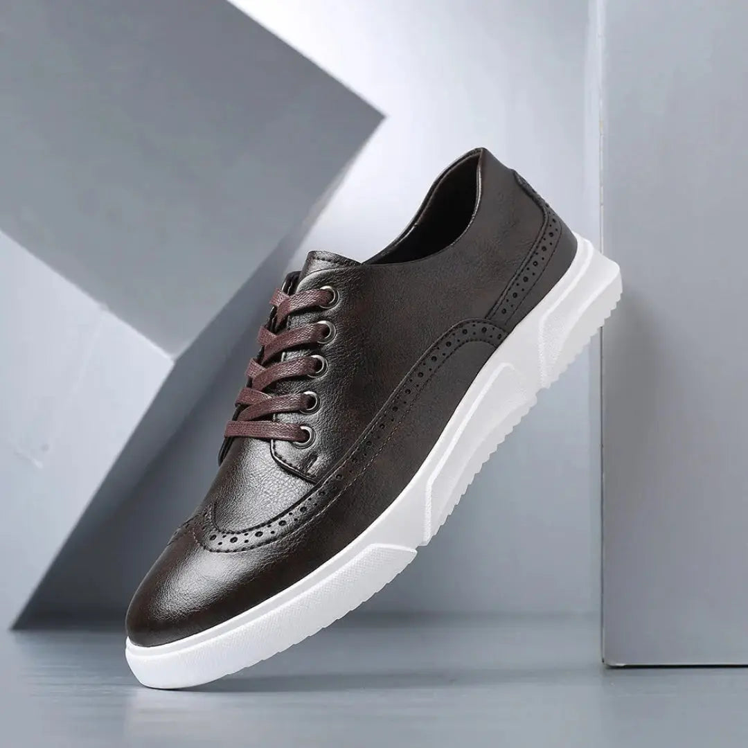 Men's black faux leather wingtip brogue sneakers with white sole and classic perforated detailing