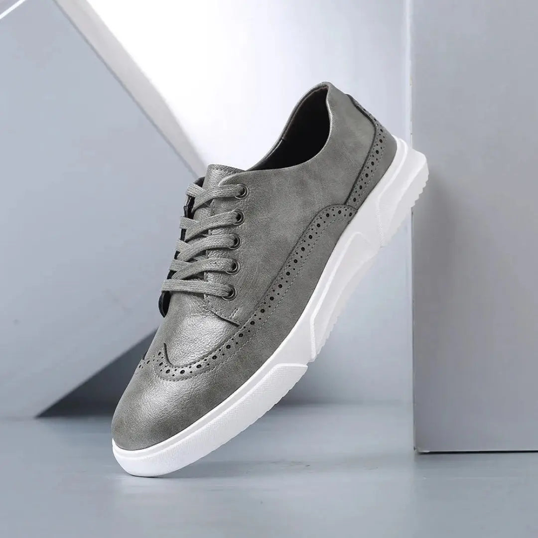 Men's black faux leather wingtip brogue sneakers with classic detailing and white sole