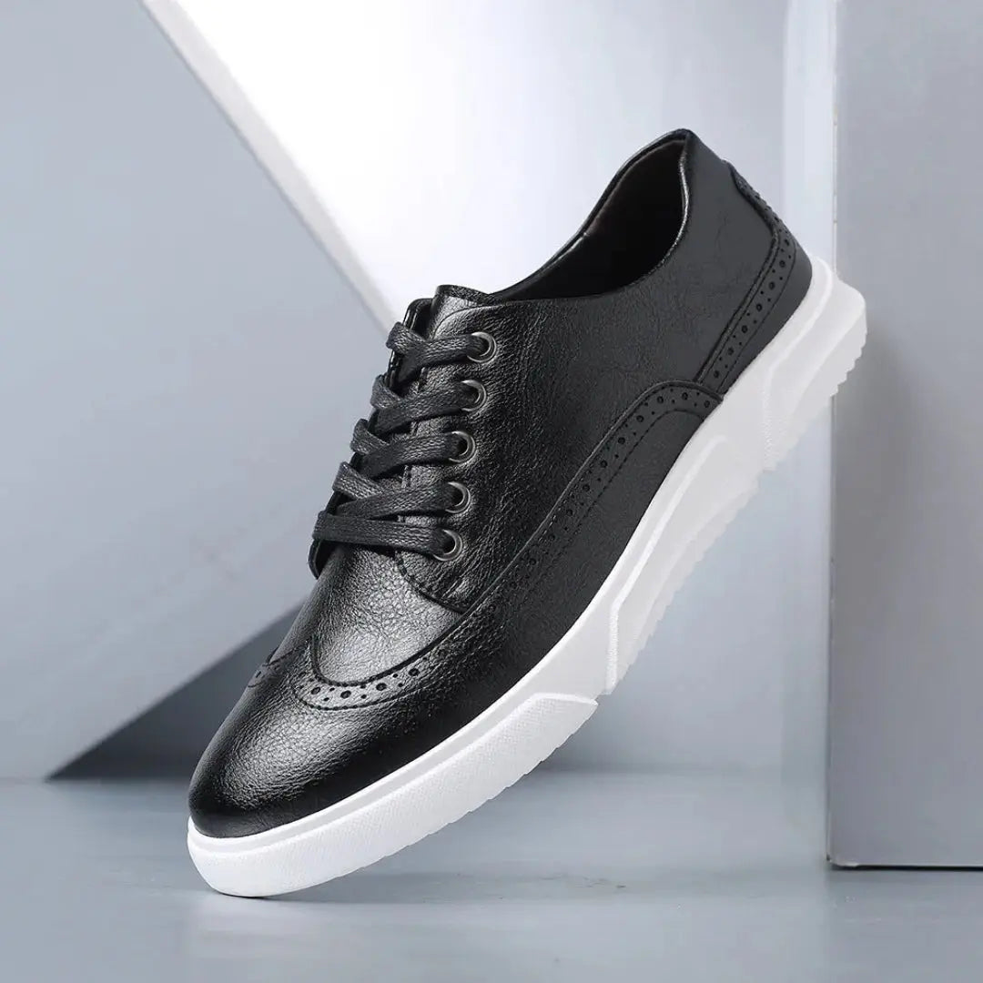 Men's black faux leather wingtip brogue sneakers with white sole and classic perforated detailing