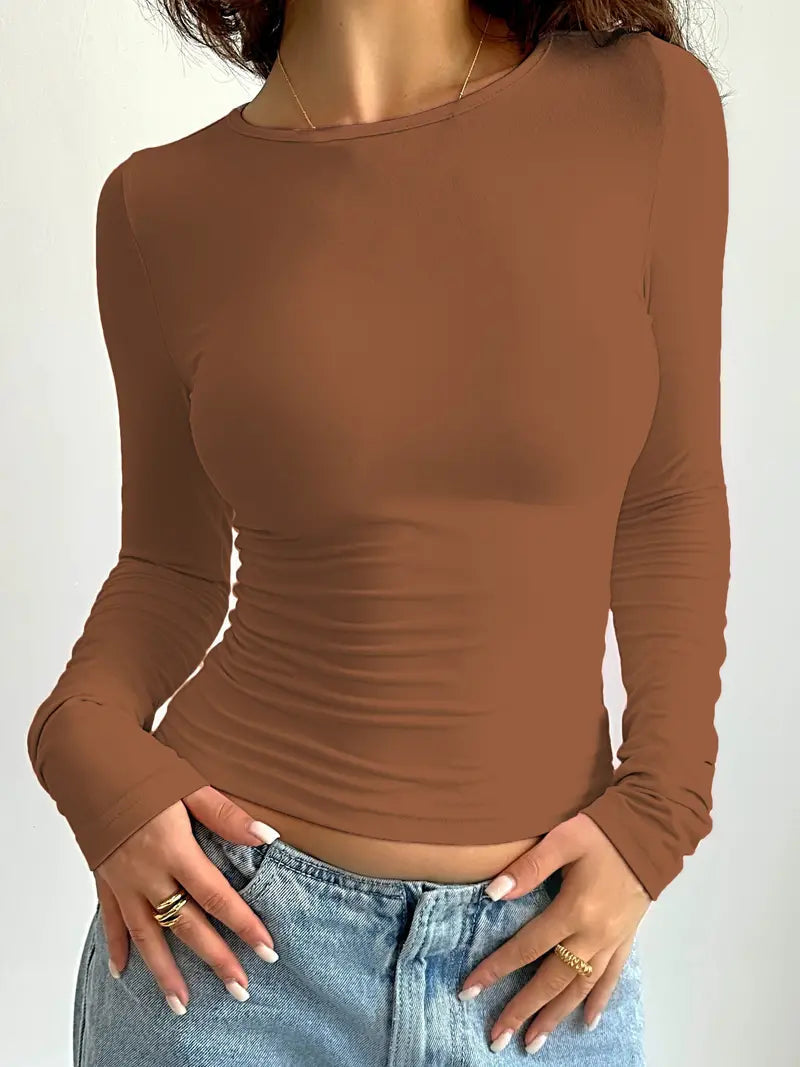 Women's slim fit long sleeve top in pastel pink, ultra-stretchy fabric with smooth body-hugging silhouette