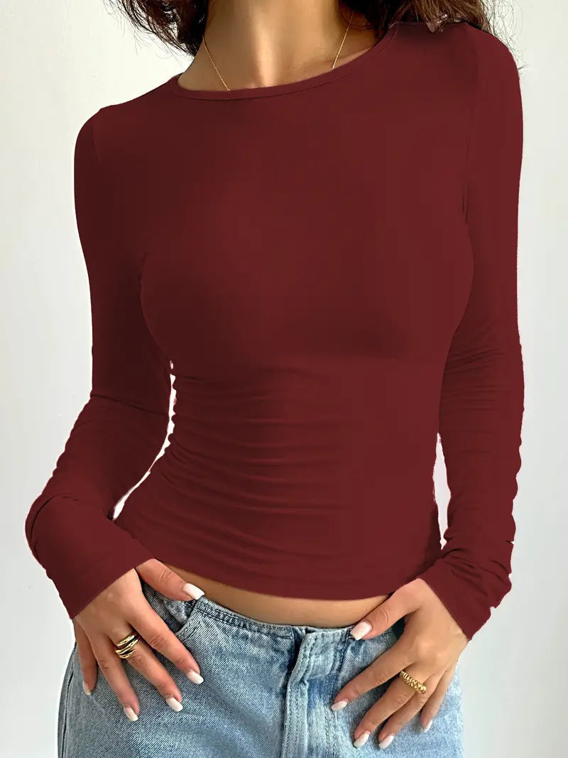 Women's slim fit long sleeve top in pastel pink, ultra-stretchy fabric with a smooth body-hugging silhouette
