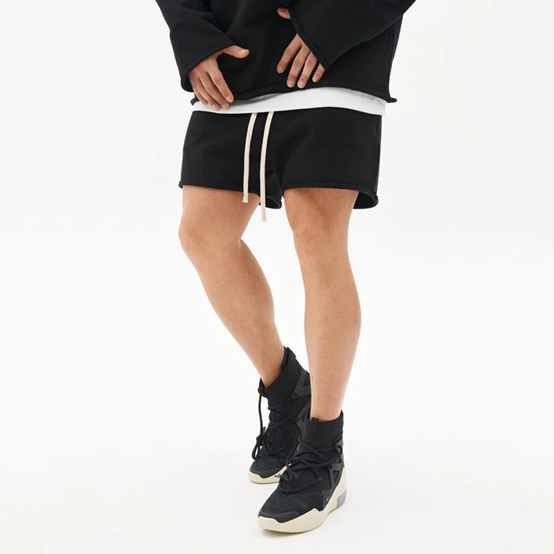 Unisex French terry lounge shorts in neutral tone with relaxed fit and adjustable drawstring waist