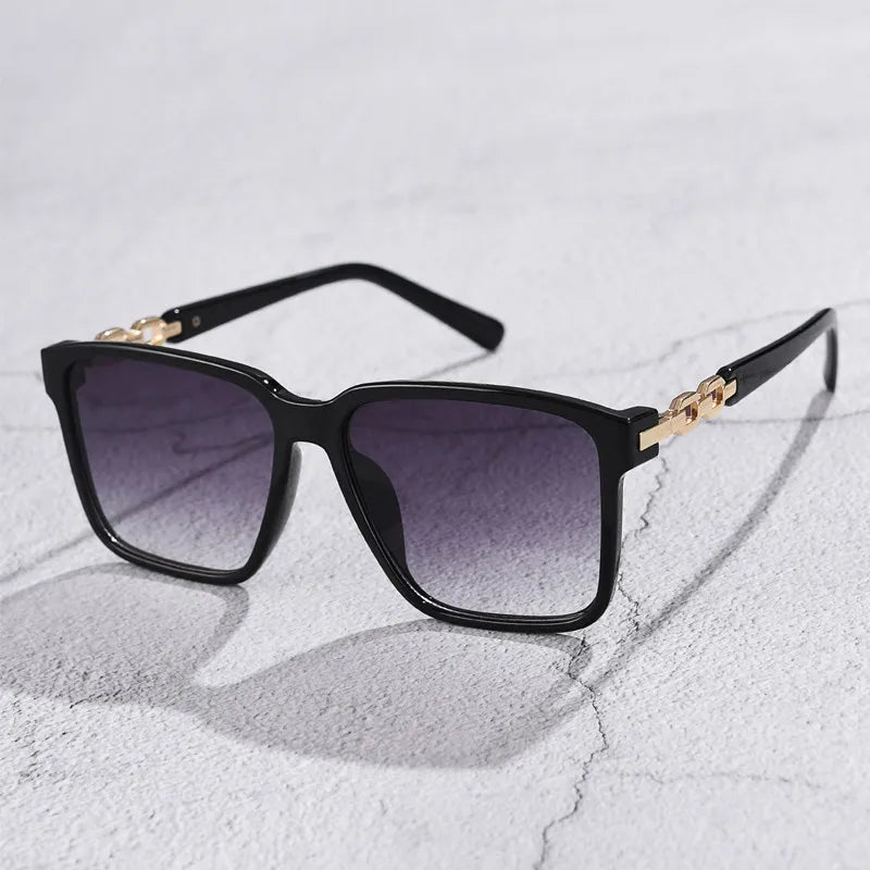 Square gradient lens sunglasses with gold chain accent arms, retro-modern style for fashion-forward women