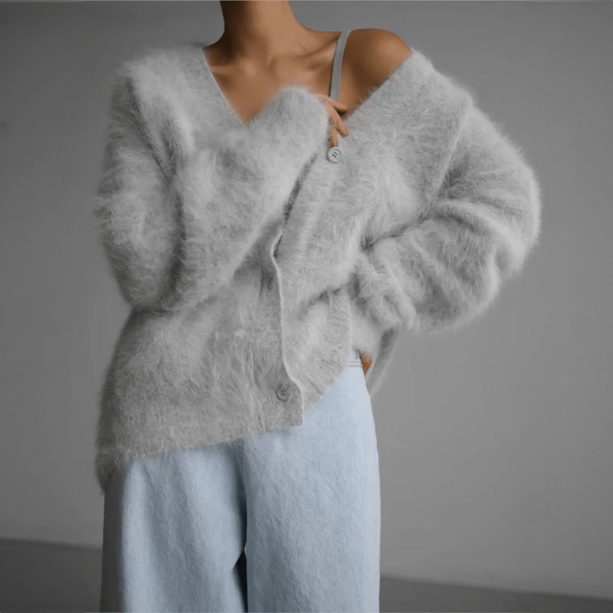 Women's oversized fluffy knit cardigan with deep V-neck and dramatic sleeves for cozy layered looks