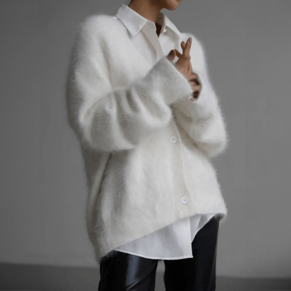 Women's fluffy oversized cardigan with deep V-neck, plush knit texture, and relaxed silhouette for layering