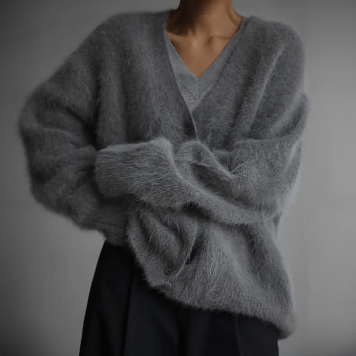 Women's fluffy oversized cardigan with deep V-neck, plush knit texture, and relaxed silhouette for effortless layering