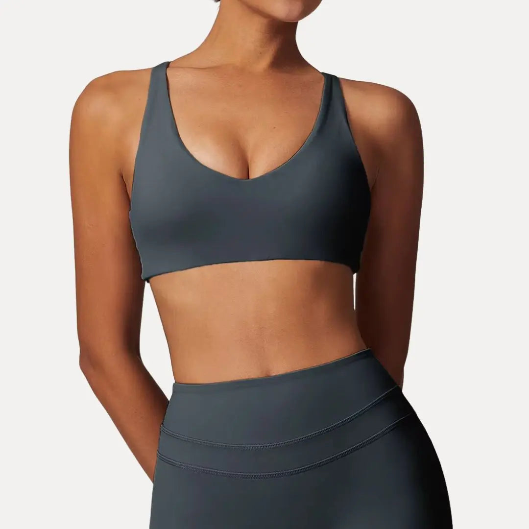 Lyra black sports bra with adjustable crisscross back straps, lightweight breathable design for active women