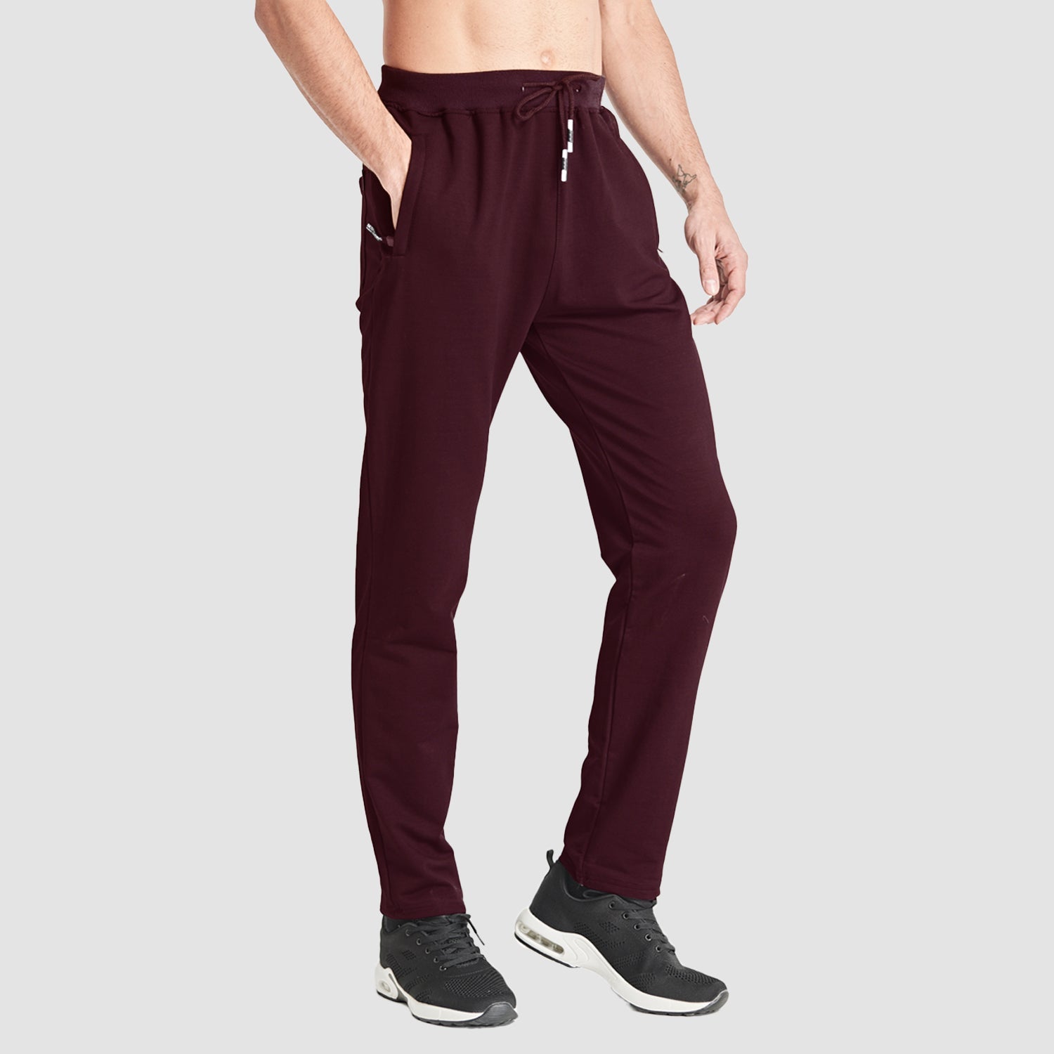 Men's gray slim-fit sweatpants with zip pockets and adjustable waist for gym training