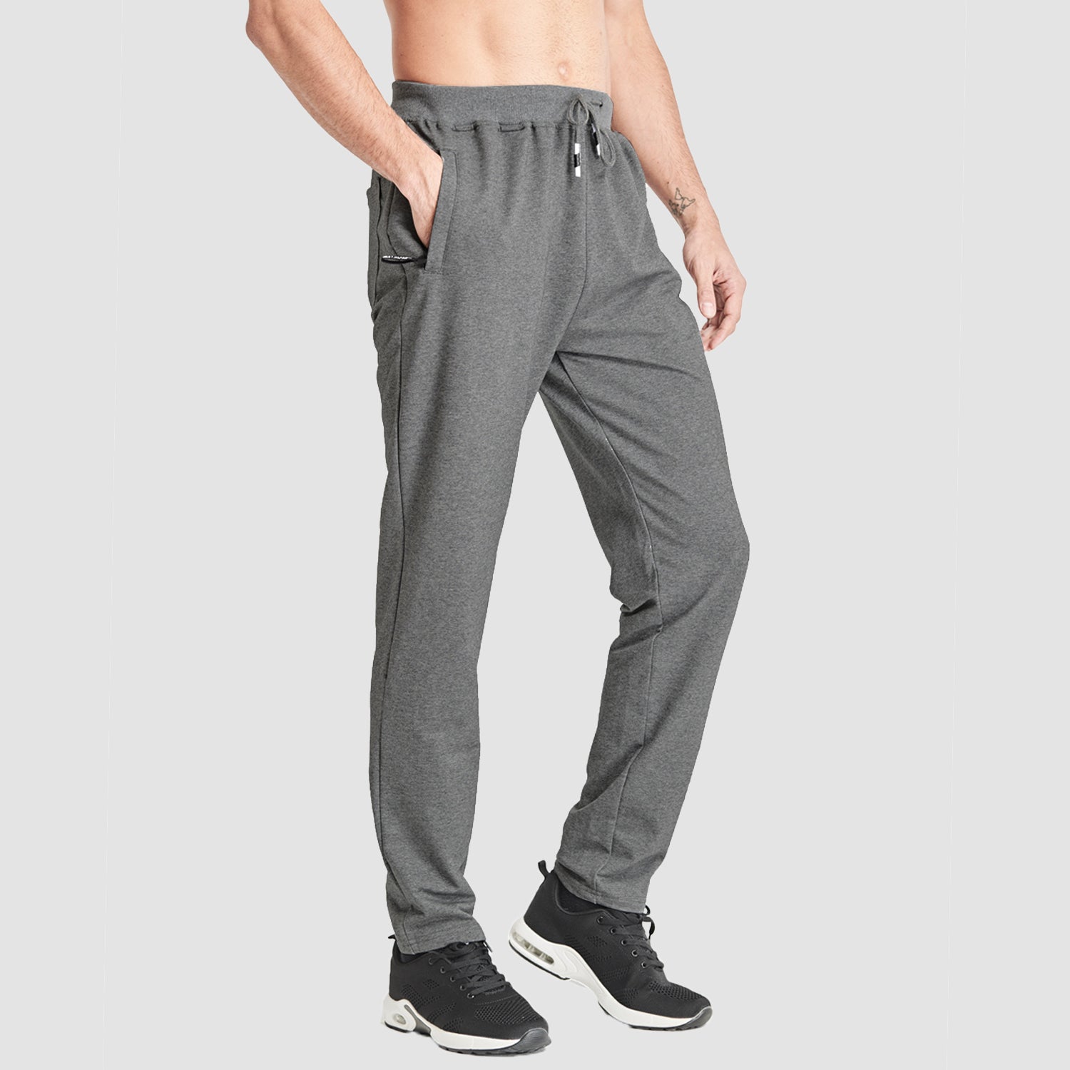 Men's gray slim-fit sweatpants with adjustable waist, zip pockets, breathable cotton blend for gym