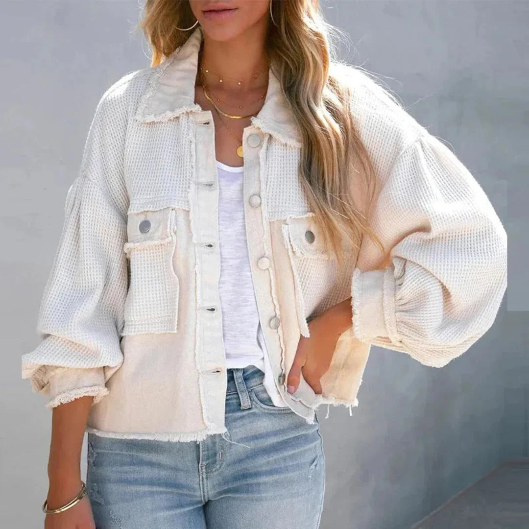 Blue patchwork denim jacket with waffle-knit texture, balloon sleeves, and oversized streetwear silhouette