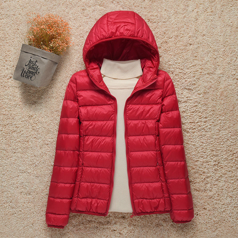 Women's hooded puffer jacket warm lightweight silhouette with attached hood for outdoor adventures