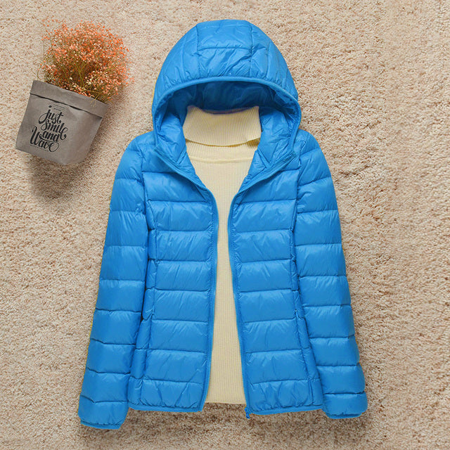 Women's hooded puffer jacket warm lightweight cozy silhouette ideal for outdoor cold-weather adventures