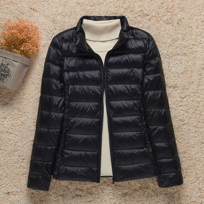Women's hooded puffer jacket warm lightweight silhouette with attached hood for outdoor adventures