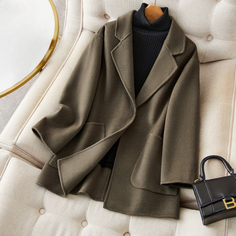 Women's relaxed fit mid-thigh wool coat in neutral tone with effortless silhouette and premium warmth