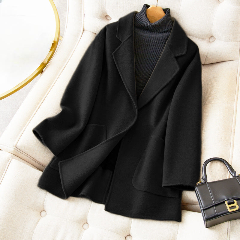 Women's relaxed fit mid-thigh wool coat in neutral tones with effortless silhouette and premium warmth