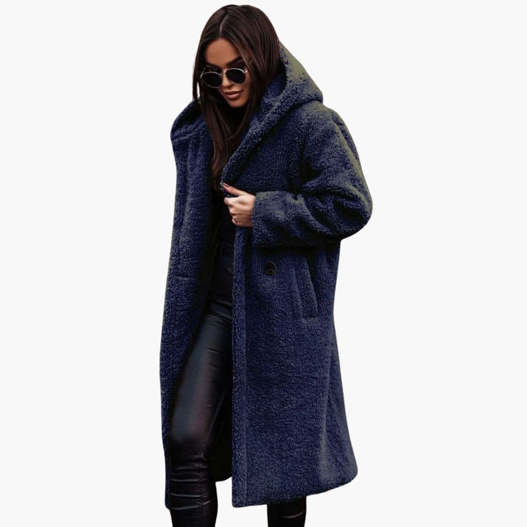 Women's long winter coat with hood, button closure, knee-length silhouette, textured exterior and side pockets