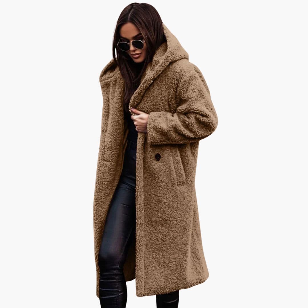 Women's long winter coat with hood, button closure, knee-length silhouette, textured exterior and side pockets