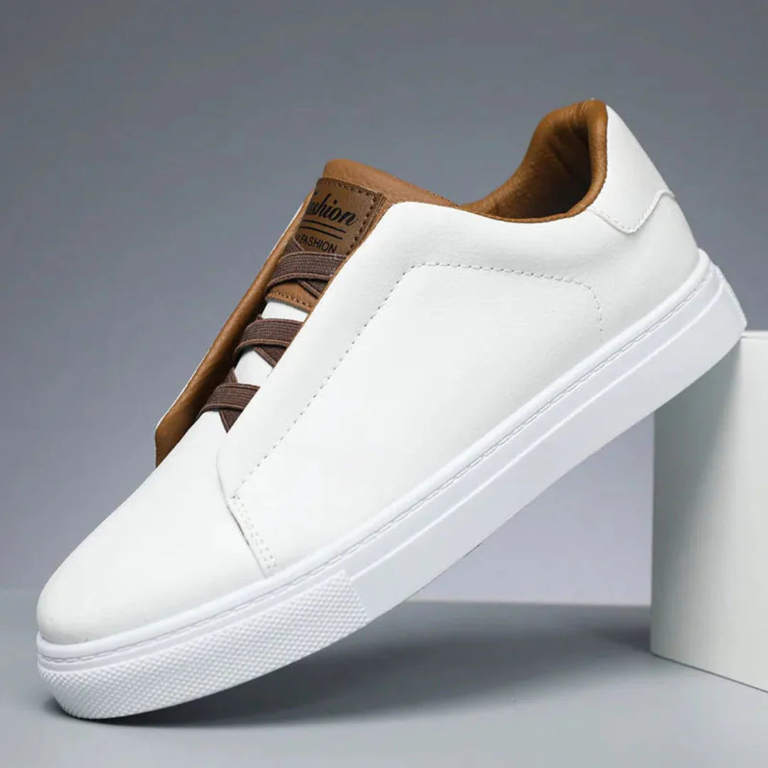 Men's white minimalist leather sneakers with padded collar and sleek low-profile synthetic upper