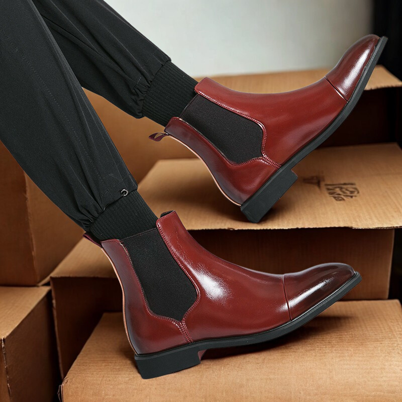 Men's black leather Chelsea ankle boots with elastic side gussets, sleek dress style for versatile wear