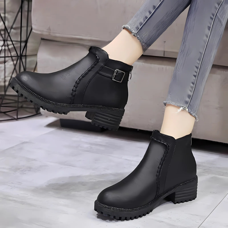 Women's black faux leather ankle boots with lug sole low block heel and rounded toe