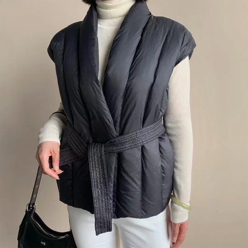 Women's belted quilted puffer vest in soft wrap cocoon silhouette with duck down insulation