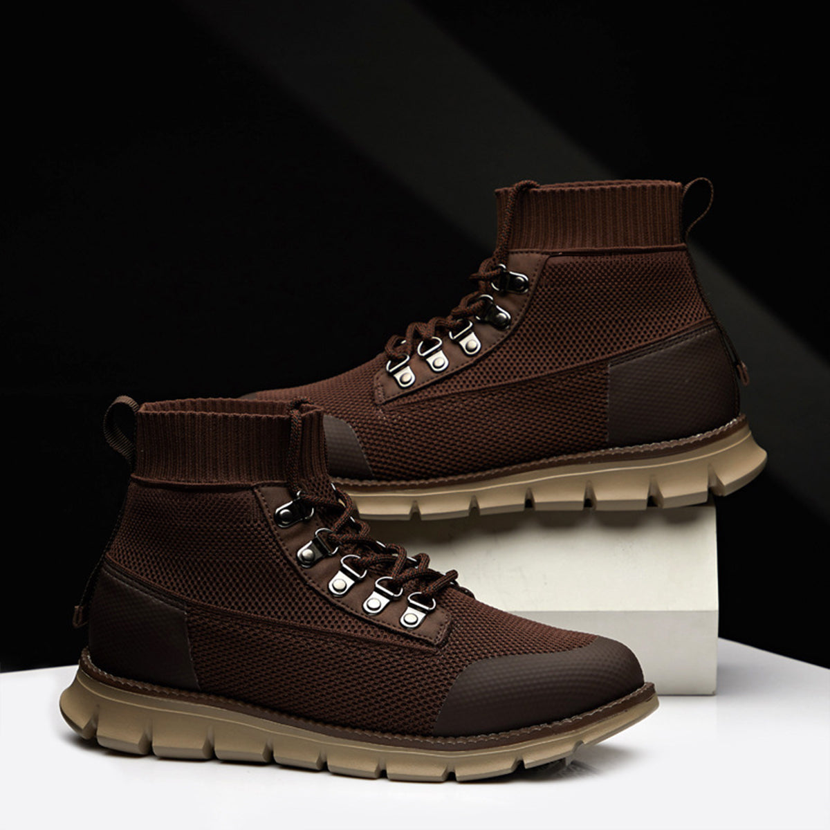 Men's brown ankle-length lace-up boots with ribbed cuff, lug sole, and standard casual fit