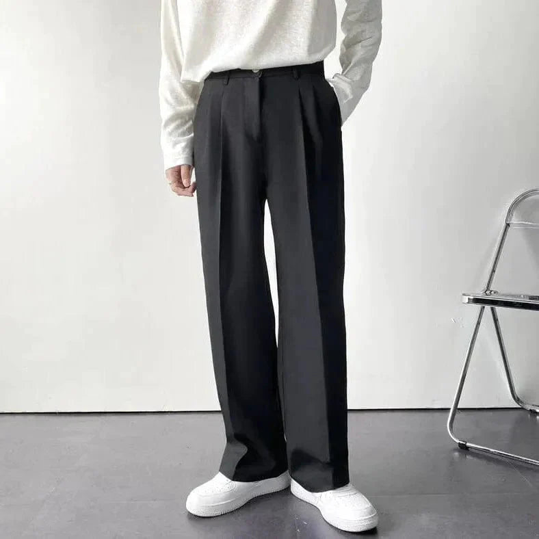 Matte wide-leg trousers with tailored pleats, relaxed silhouette in minimalist style for modern professionals