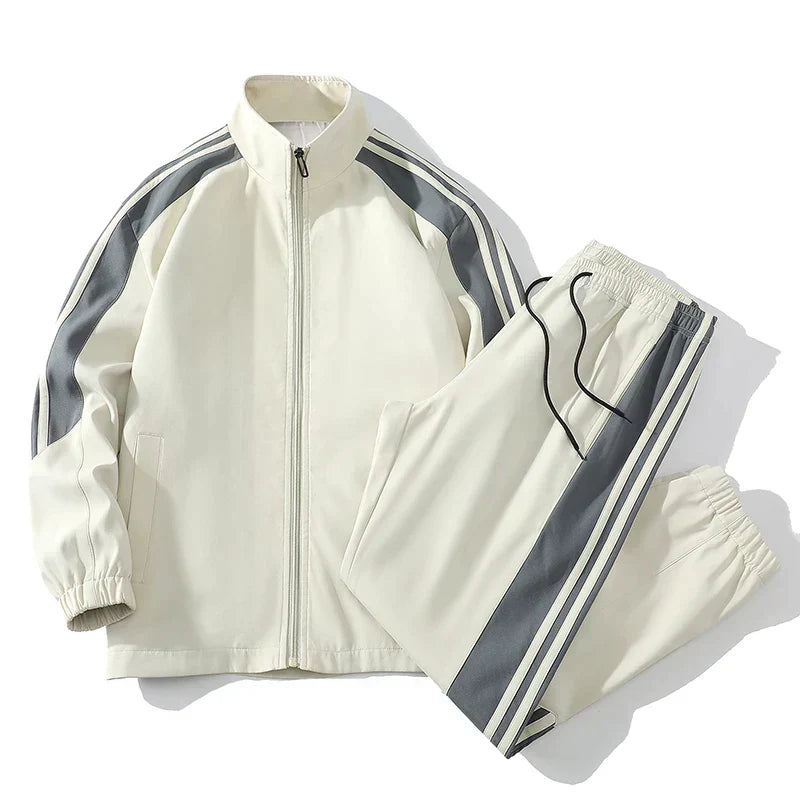 Men's gray jogger set with zip-up jacket, modern stripe detailing for athletic streetwear