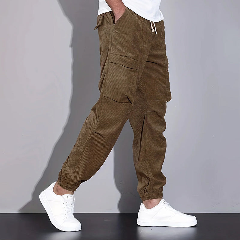Men's dark corduroy cargo jogger pants with drawstring waist and multi-pocket utility design