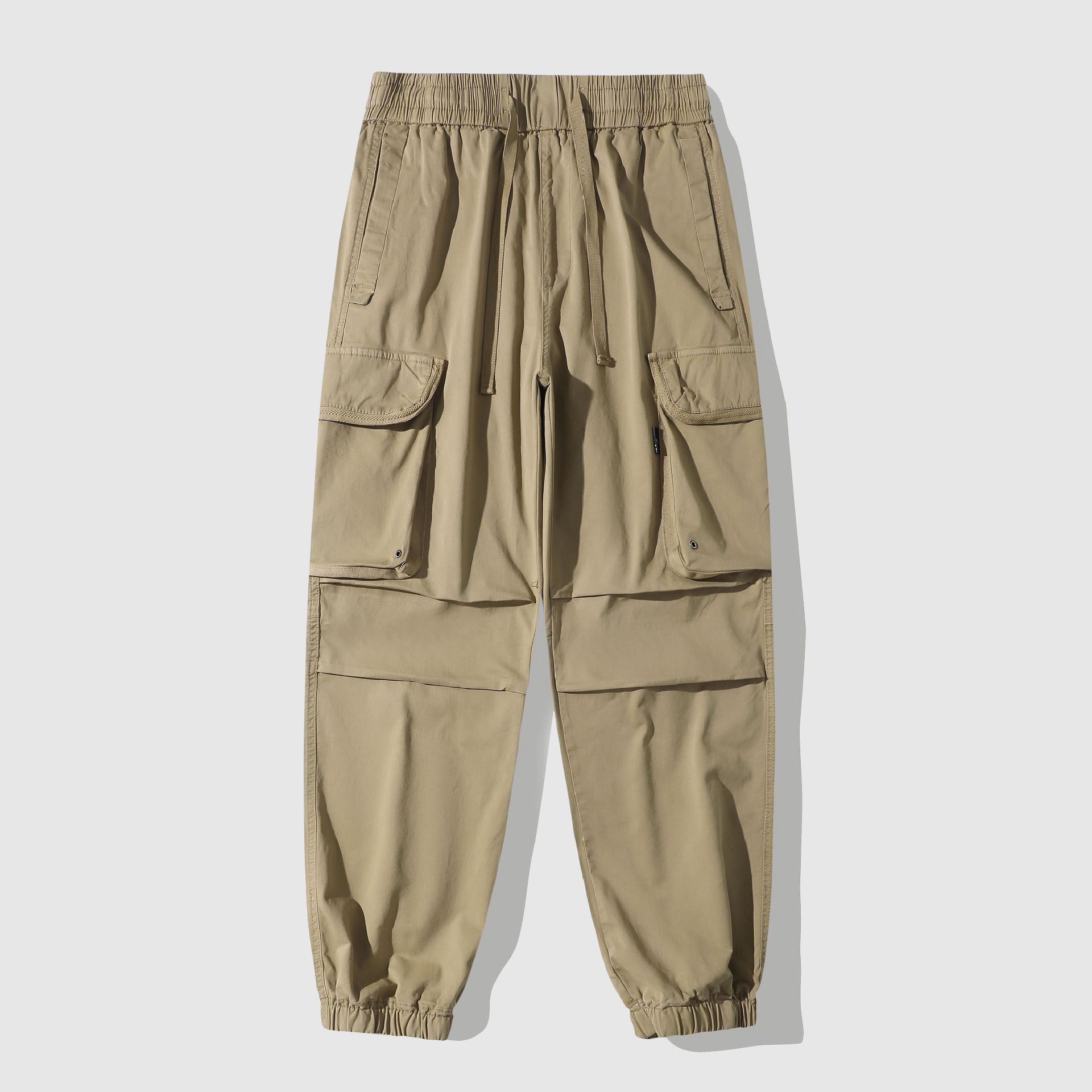 Men's vintage washed cargo utility pants with oversized pockets and cinched cuffs street style