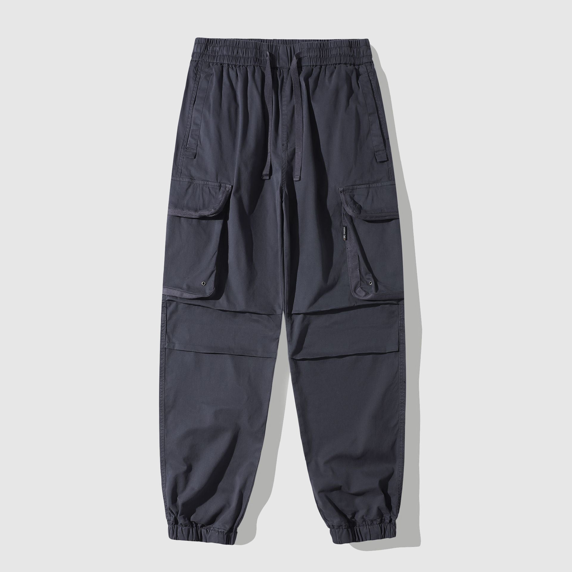 Men's vintage washed cargo utility pants with oversized pockets and cinched cuffs street style