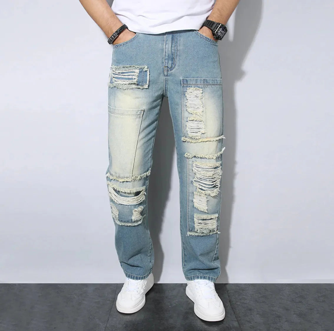 Men's loose fit distressed blue jeans with ripped details and heavy-washed streetwear finish