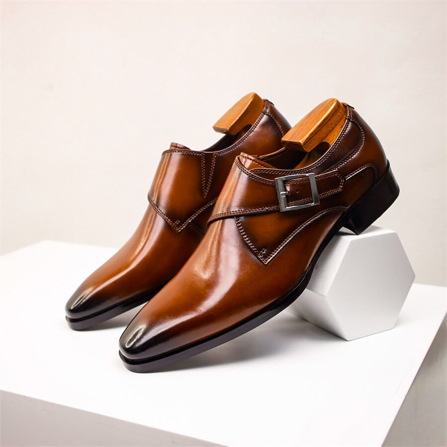 Men's black monk strap dress shoes with single buckle closure and pointed toe for formal occasions