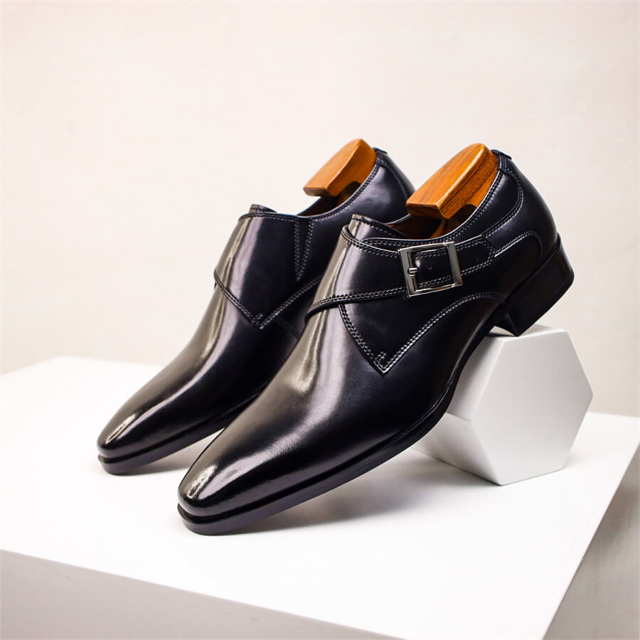 Men's black monk strap dress shoes with single buckle closure, pointed toe, polished formal finish