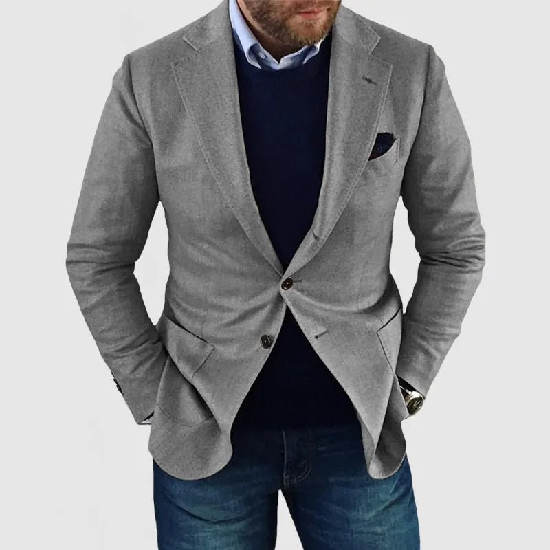 Men's navy tailored two-button blazer with notched lapels and welt pockets for smart casual wear