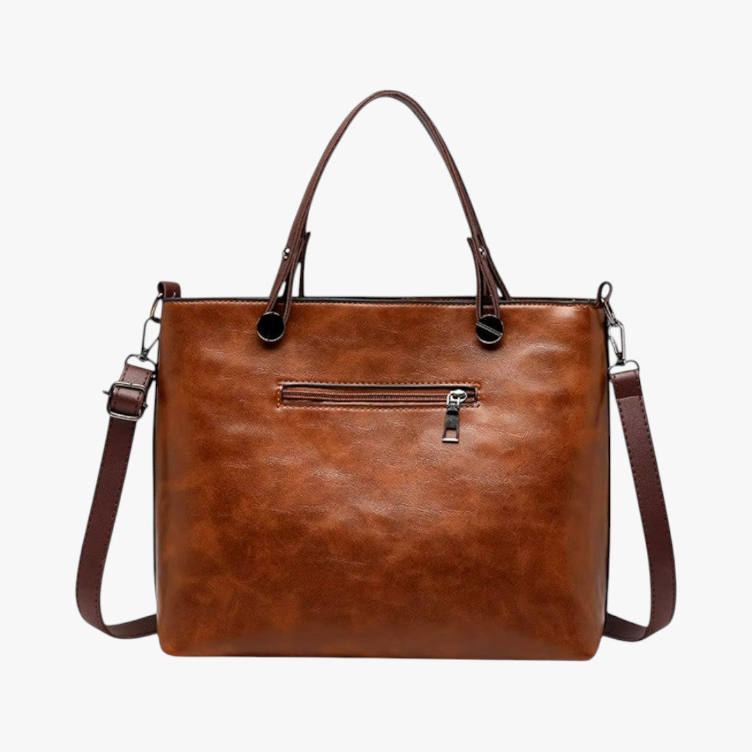 Women's vintage brown leather handbag with multiple pockets and adjustable strap for daily use