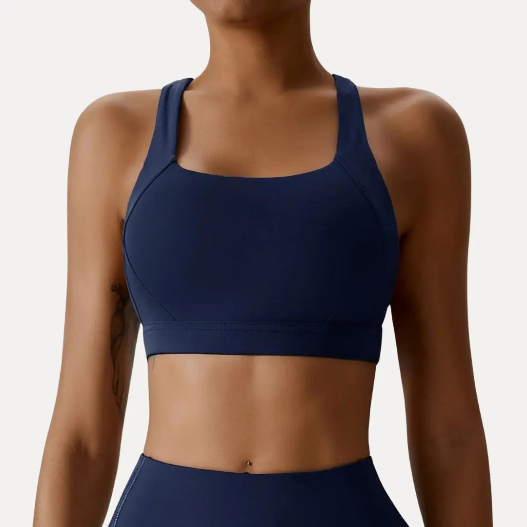 Black cross-back sports bra with square neckline and crisscross straps for high-support workouts