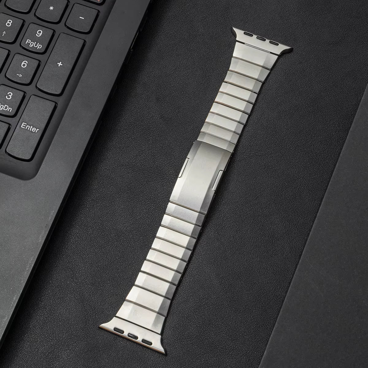 Brushed stainless steel Apple Watch link bracelet with matte finish and low-profile secure clasp