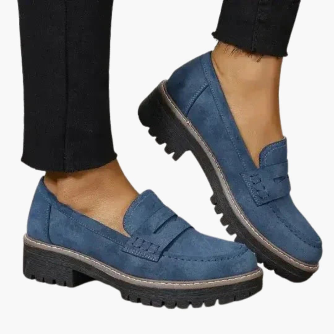 Women's slip-on moccasins with thick textured sole, rounded toe, and subtle topstitching for all-day comfort