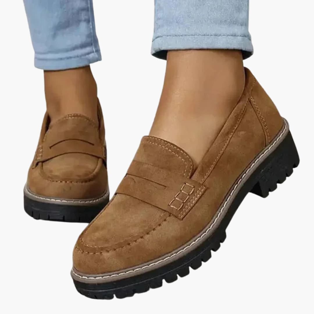 Women's slip-on moccasins with thick textured sole, rounded toe, and subtle topstitching for all-day comfort