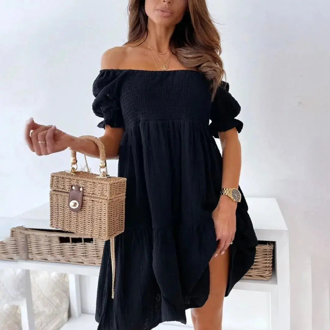 White cotton gauze off-shoulder smocked mini dress with puff sleeves and flared tiered skirt
