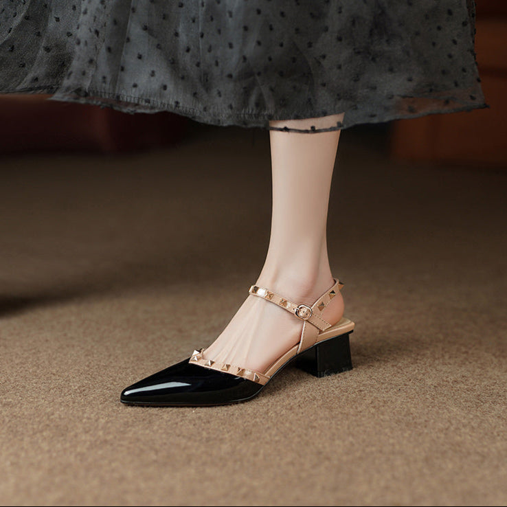 Women's black patent glossy pointed-toe block heel pumps with studded edge trim