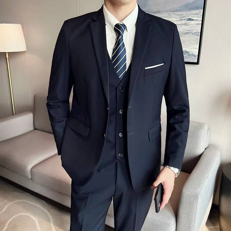 Men's slim fit three-piece suit in classic navy blue with matching vest, jacket, and tailored pants