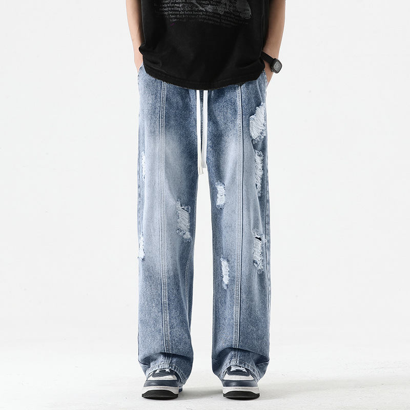 Nexus distressed wide-leg denim joggers in washed blue with heavy fraying for streetwear style
