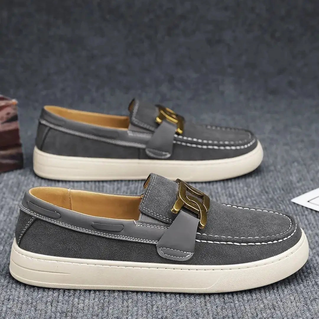 Men's brown leather slip-on loafers with gold-tone buckle accent and lightweight durable sole